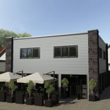 Damwandplaat T18DR wand lichtgrijs als gevelbekleding van een modern gebouw met ramen