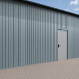 Damwandplaat T7M Pelsgrijs RAL 7000 als wandbekleding op een gebouw met deur