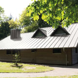 Felsplaat 33/500-LE, grijs aluminium, op een dak met dakkapellen en schoorsteen