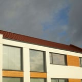 Staande felsplaat PD-510-S trapezium terracotta op een plat dak van een modern gebouw