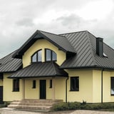 Huis met grijs aluminiumkleurig felsdak PD-510-S Micro, met gevel en luifel