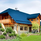 Huis met felsplaat PD-510-S dak in Gentiaanblauw (RAL 5010), zijaanzicht