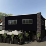 Gebouw met wandbekleding van golfplaat 18/1064 in Gitzwart RAL 9005, toepassingsvoorbeeld