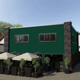 Gebouwgevel met golfplaat PF25W Mosgroen als wandbekleding