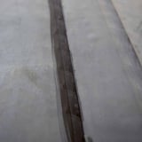 Detail van een verlijmde naad met zwart EPDM naadband op een dakbedekking