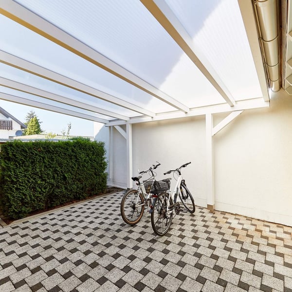 Carport met 16 mm acrylglas kanaalplaten opaal wit als dak, twee fietsen eronder