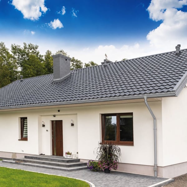 Woning met grijs aluminiumkleurige (RAL9007) Niagara dakgoten en regenpijpen, compleet systeem