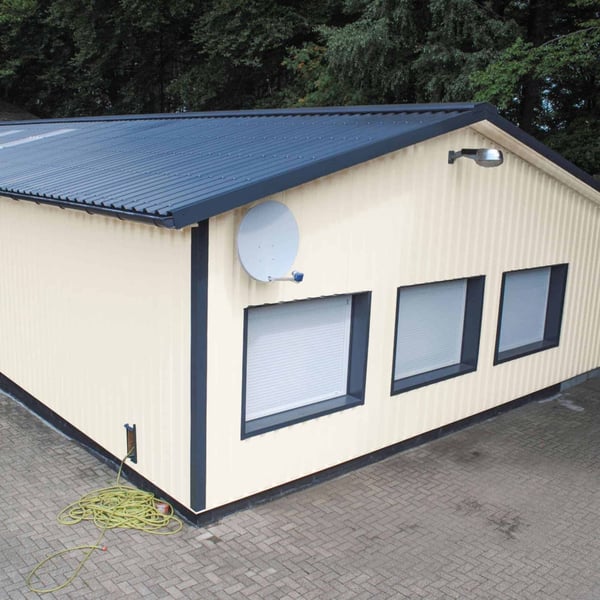Damwandplaat 35/207 wand, zuiverwit RAL 9010, gemonteerd aan een garagegebouw