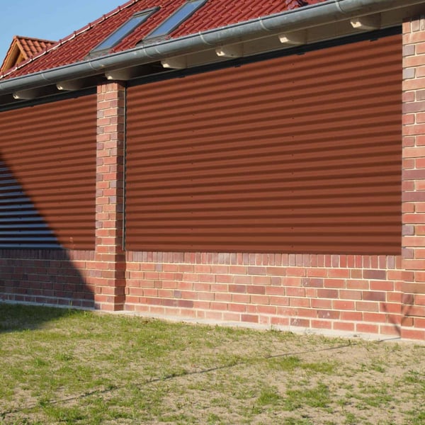 Wandbekleding van koperbruine golfplaat 18/1064, 0,50 mm staal, op bakstenen muur