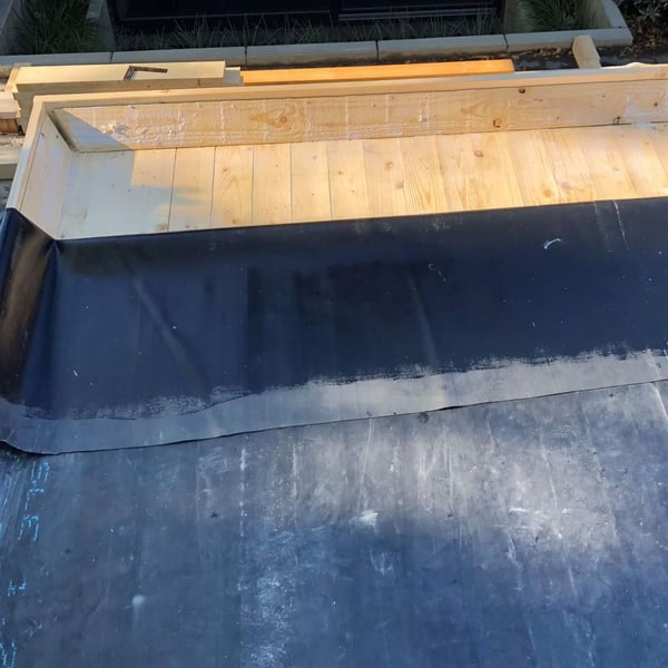 Plaatsing van de dakbedekking met BlueTek oppervlaklijm op houten dak, totaalbeeld van het dakoppervlak